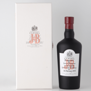 j&b ultima 128 whisky black bottle standing beside white box