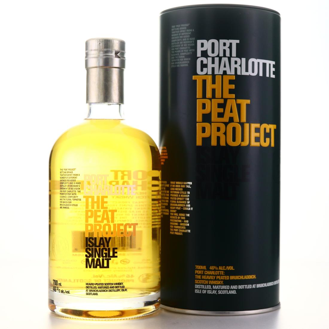 port charlotte the peat project bottle front standing beside a black metal tin